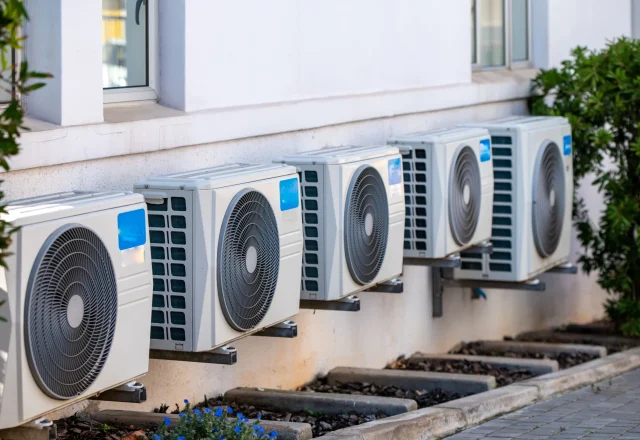 Outdoor condensing units mounted along the side of a building